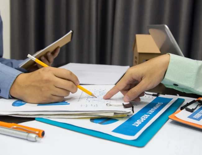 Business man Writing expense information in home office.team work concept